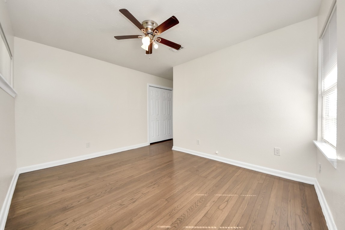 119 Burke Road Pasadena, TX 77506 - Photo 28 of 47 an empty room with wooden floor and windows