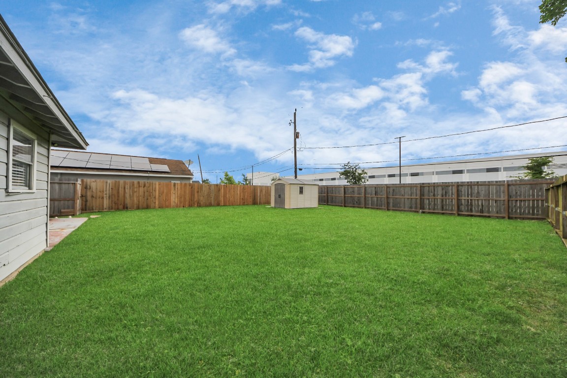 119 Burke Road Pasadena, TX 77506 - Photo 42 of 47 a view of a backyard with grass and a garage