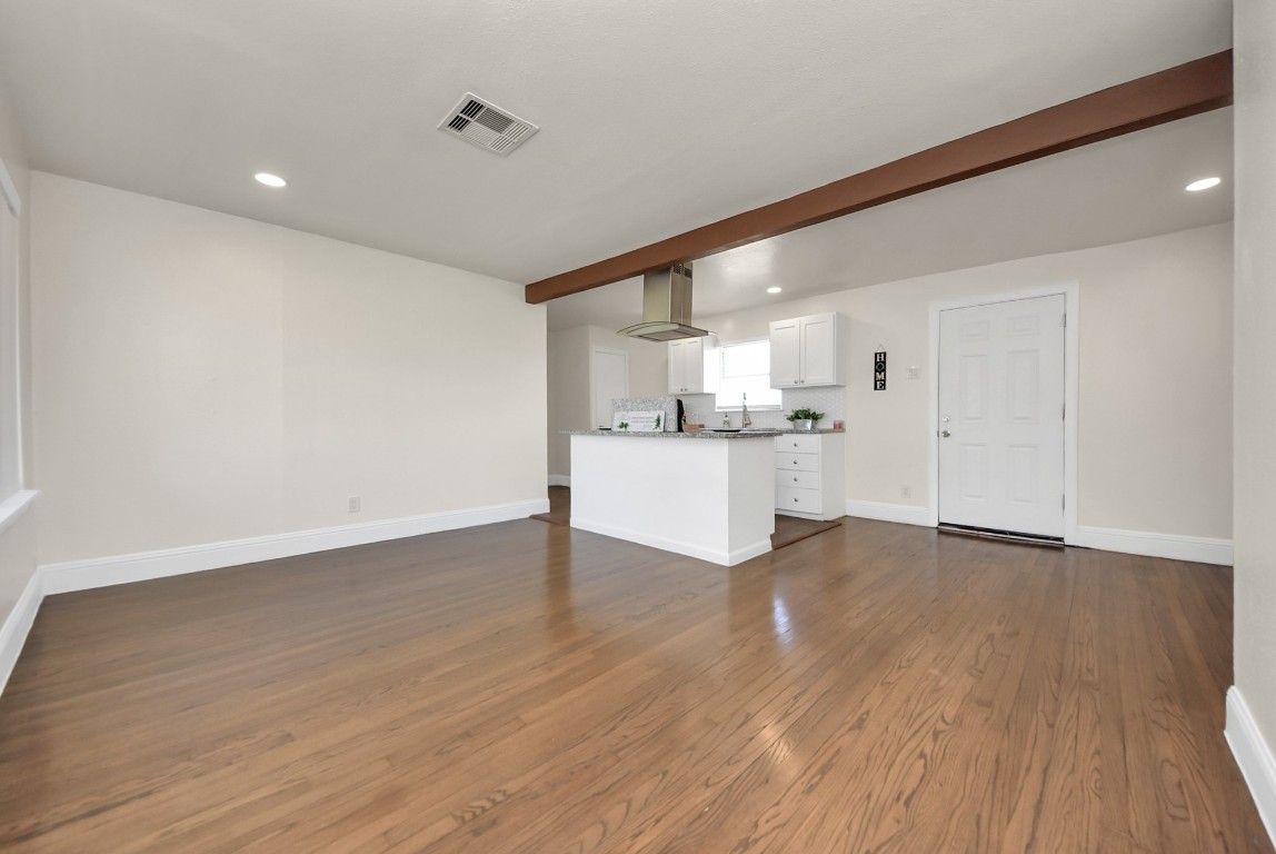 119 Burke Road Pasadena, TX 77506 - Photo 5 of 47 a view of a kitchen with a sink and dishwasher with wooden floor