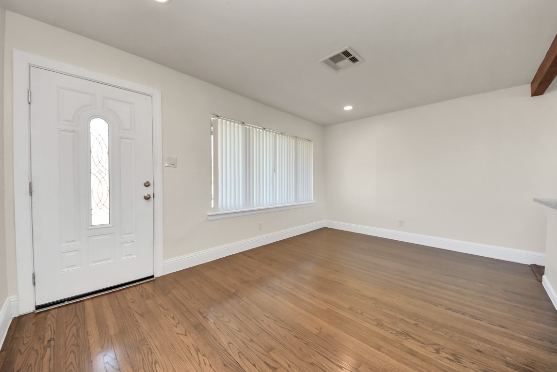 119 Burke Road Pasadena, TX 77506 - Photo 7 of 47 a view of an empty room with wooden floor and a window