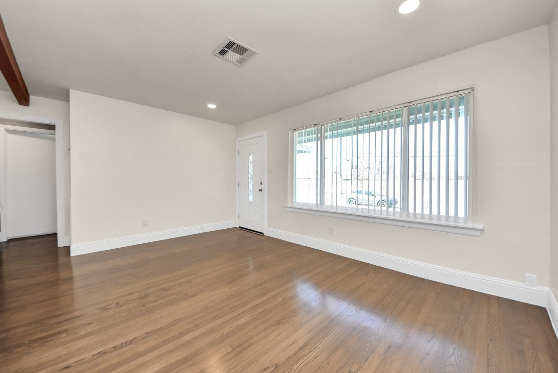 119 Burke Road Pasadena, TX 77506 - Photo 8 of 47 a view of an empty room with wooden floor and a window
