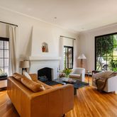 a living room with furniture fireplace and large windows