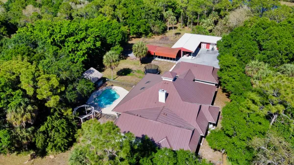an aerial view of a house with yard swimming pool and outdoor seating