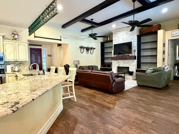 a view of a dining room with furniture and chandelier