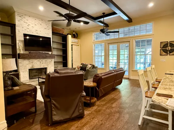 a bed sitting in a spacious bedroom next to a window