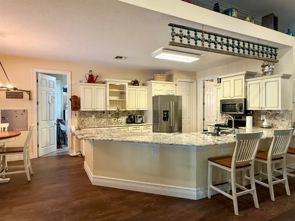 a spacious bathroom with a double vanity sink a mirror and shower