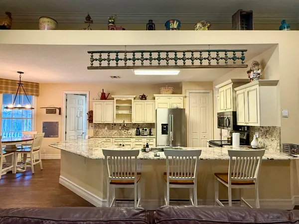 a en suite bathroom with a granite countertop shower and a sink