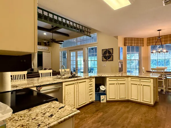a bathroom with a granite countertop double vanity and a mirror
