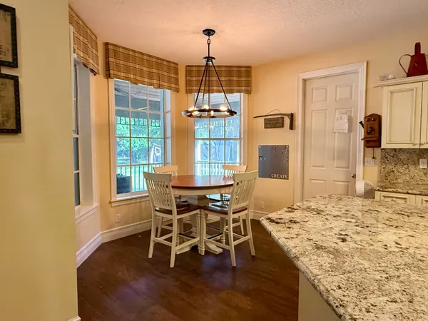 a view of a livingroom with workspace and a window