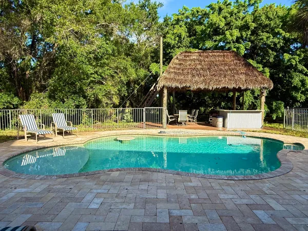 an aerial view of house with yard and swimming pool