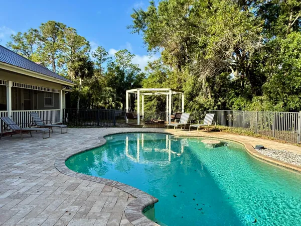 a view of a house with brick walls and potted plants