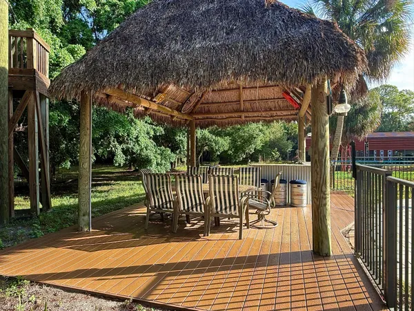 an outdoor space with seating area and trees
