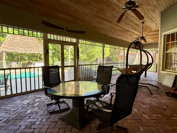 a side view of a house with outdoor seating