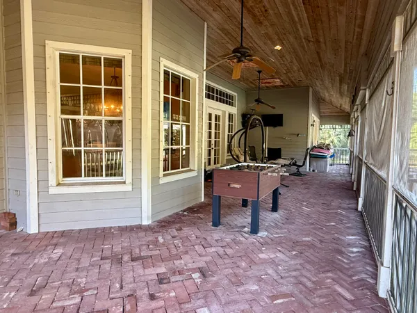a view of a porch with chairs and backyard