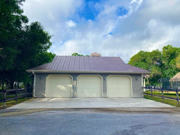 a view of a house with large trees