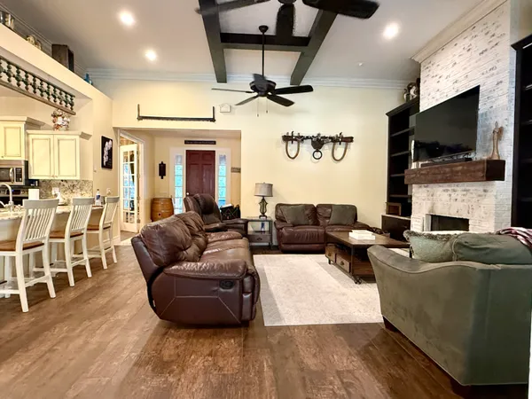 a kitchen with stainless steel appliances kitchen island granite countertop a sink stove and refrigerator