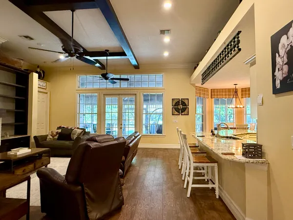 a large white kitchen with a sink and cabinets