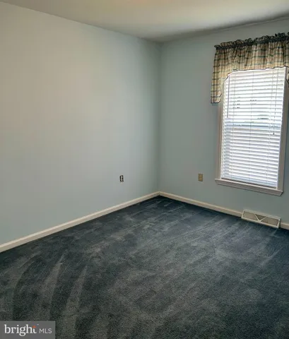 a bathroom with a granite countertop sink a toilet and a mirror
