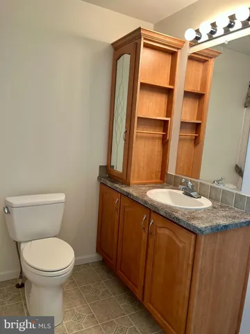a bathroom with a shower curtain and sink