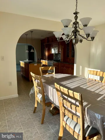 a living room with a table and chairs