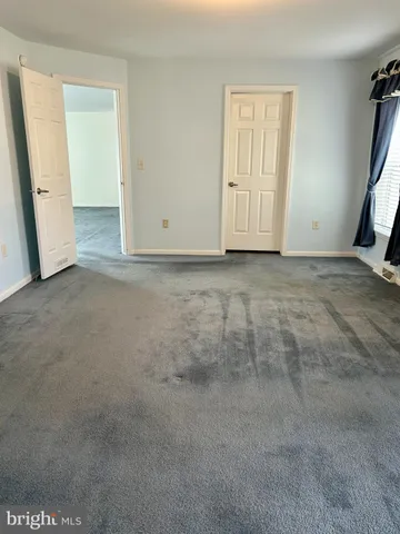 a bathroom with a granite countertop sink double vanity and mirror