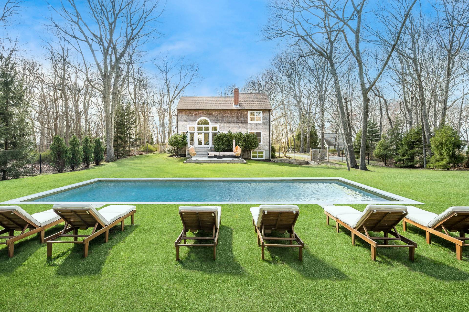 a swimming pool with outdoor seating and outdoor seating