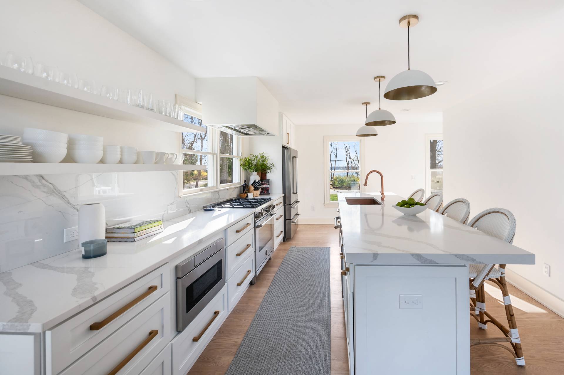 40 Dinah Rock Road Shelter Island, NY 11964 - Photo 11 of 29 a kitchen with stainless steel appliances granite countertop a sink a stove and a wooden floors