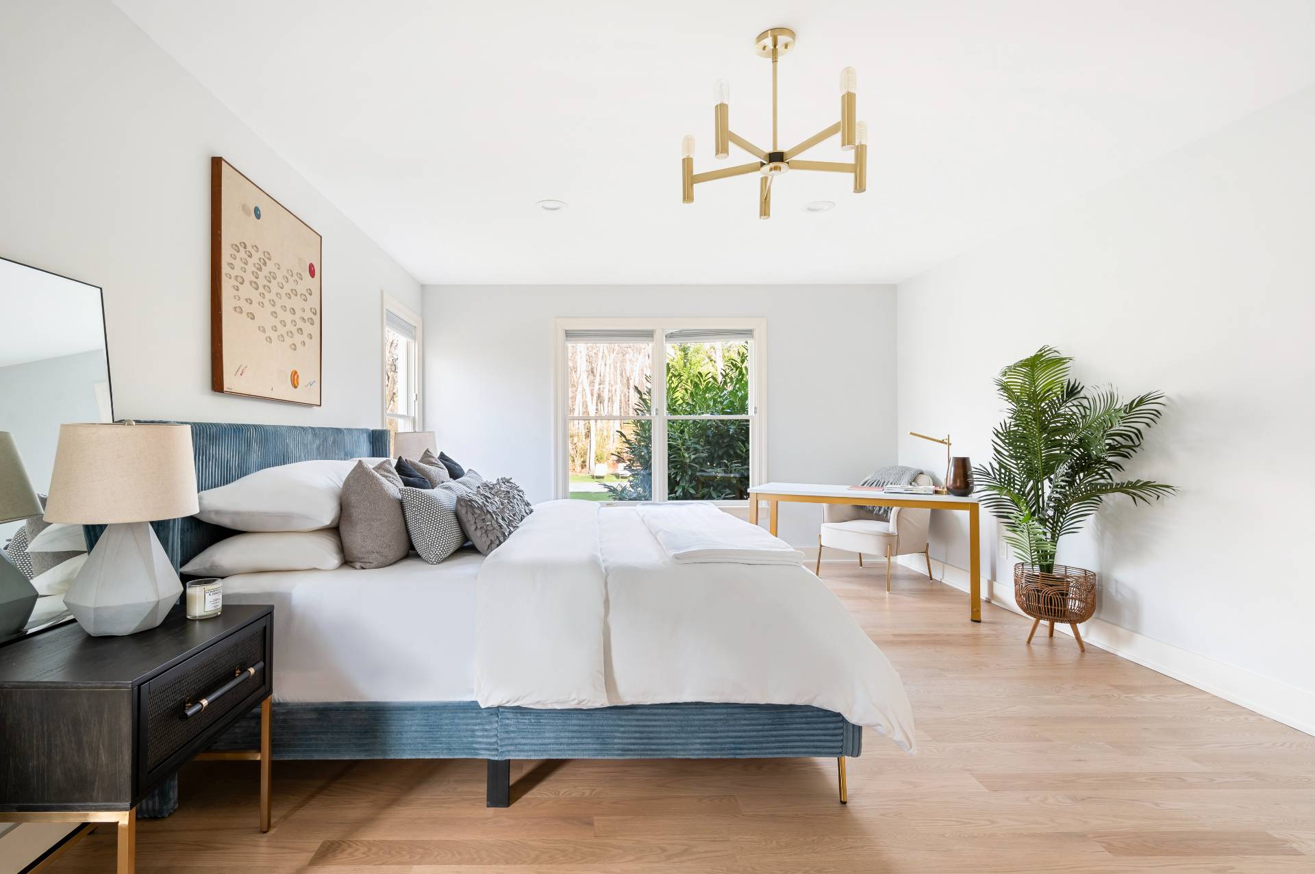 40 Dinah Rock Road Shelter Island, NY 11964 - Photo 16 of 29 a bedroom with a large bed and a potted plant