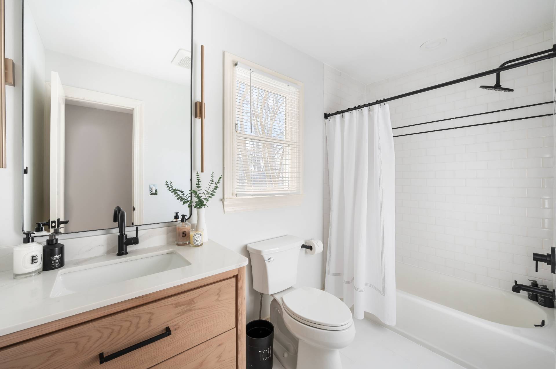 40 Dinah Rock Road Shelter Island, NY 11964 - Photo 17 of 29 a bathroom with a sink a toilet a mirror and shower