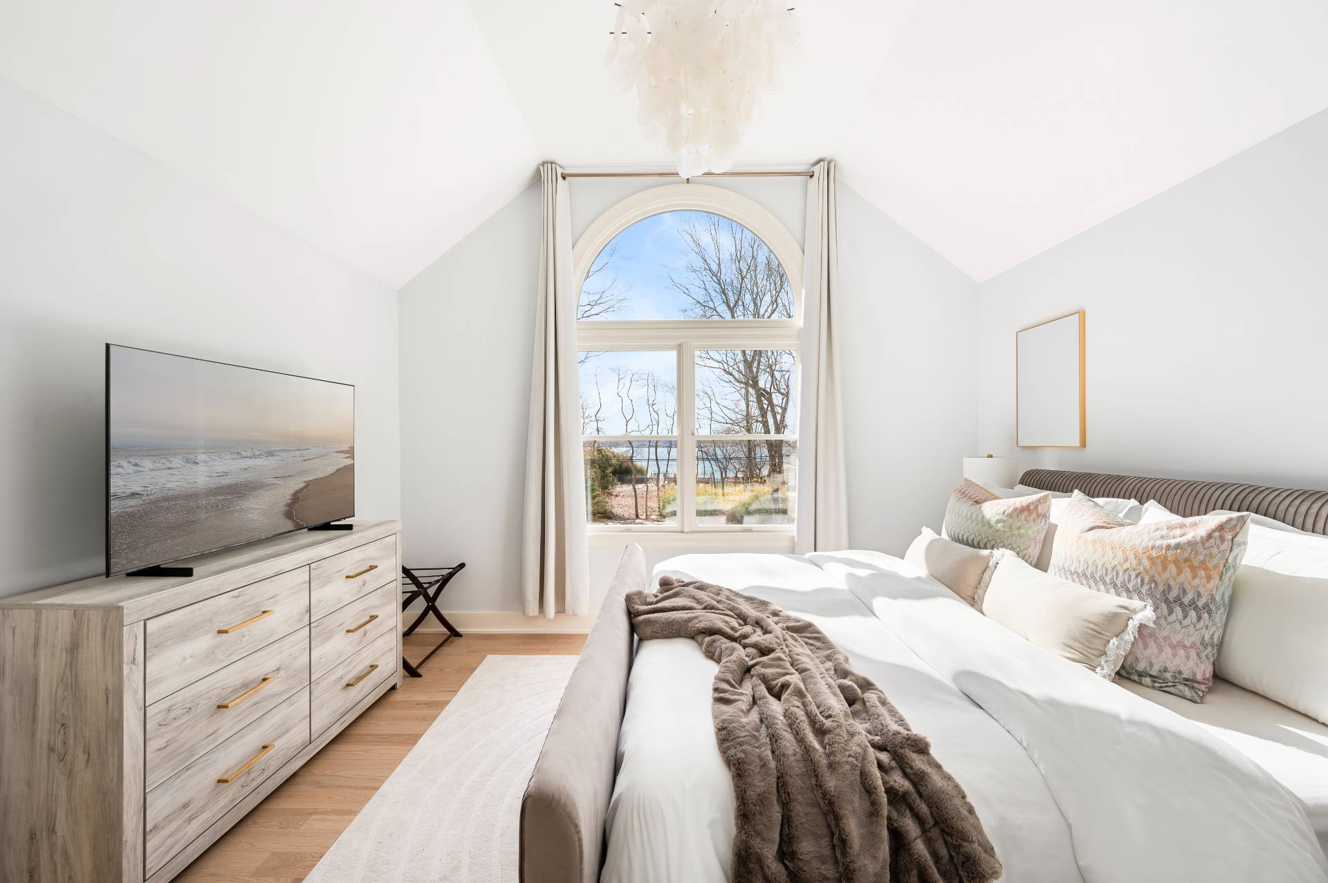 40 Dinah Rock Road Shelter Island, NY 11964 - Photo 19 of 29 a bedroom with a bed and a flat screen tv