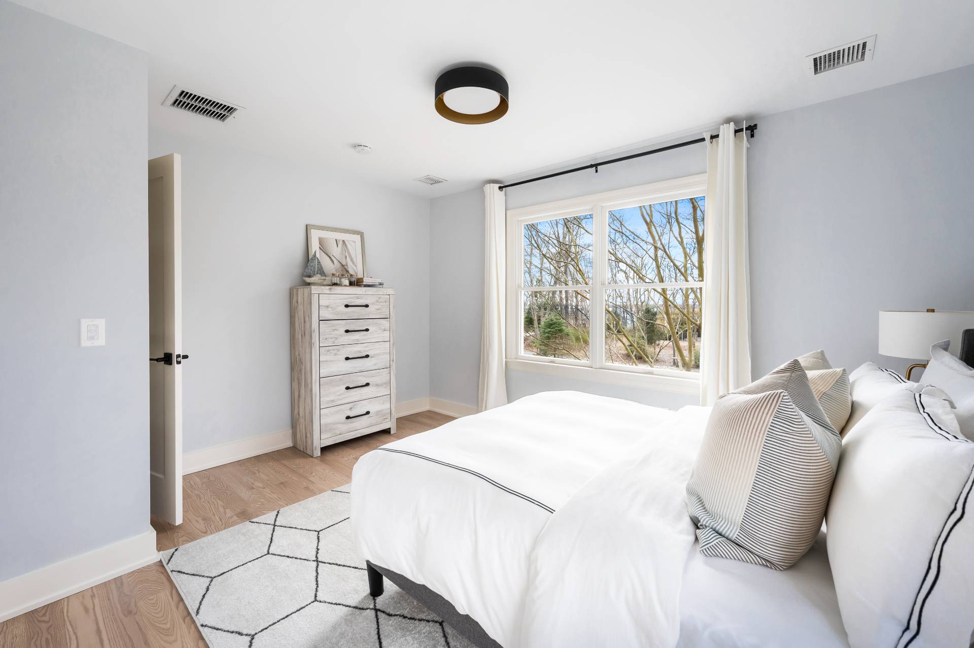 40 Dinah Rock Road Shelter Island, NY 11964 - Photo 22 of 29 a bedroom with a bed and a window