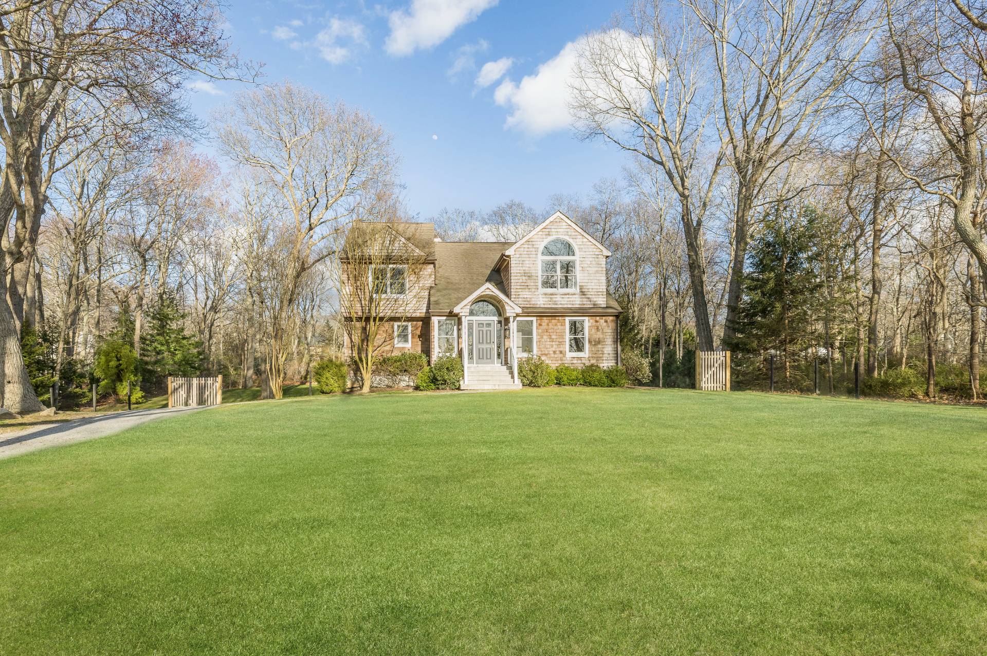 40 Dinah Rock Road Shelter Island, NY 11964 - Photo 26 of 29 a view of a big house with a big yard and large trees