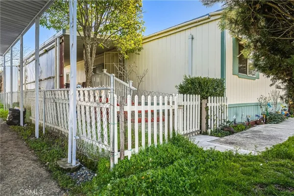 a view of a house with a small yard and floor to ceiling window