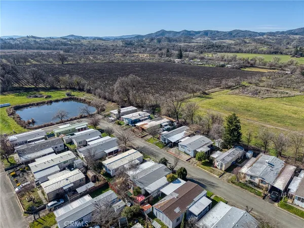 an aerial view of residential houses with outdoor space and river