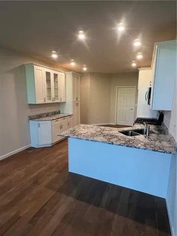 a large kitchen with kitchen island sink stainless steel appliances and cabinets