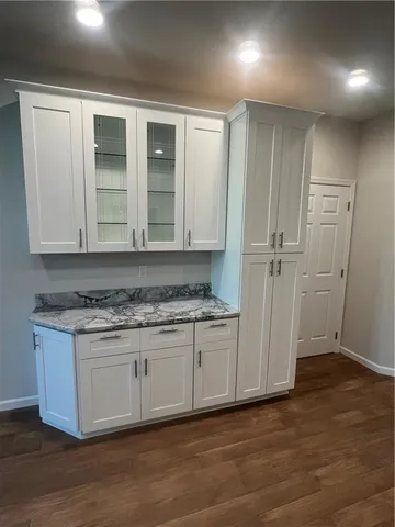 a view of granite countertop cabinets and sink