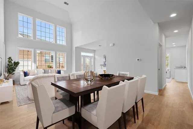 a view of a dining room with furniture and wooden floor