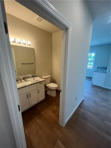 a bathroom with a granite countertop sink mirror and toilet