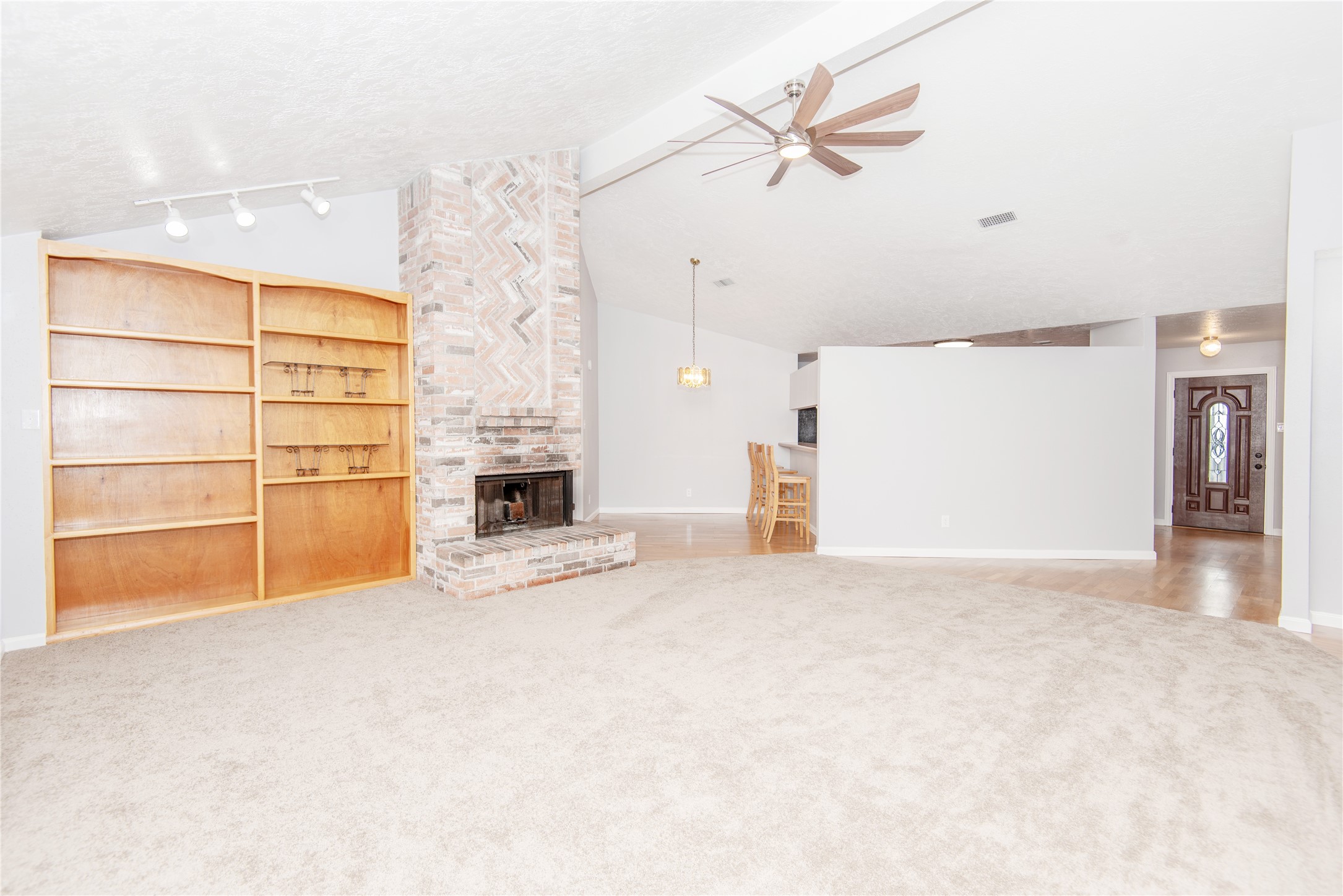 21734 Nickerton Lane Spring, TX 77388 - Photo 10 of 31 an empty room with a fireplace and fan