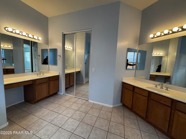 a large bathroom with a double vanity sink mirror and shower