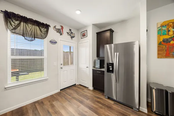 a kitchen with stainless steel appliances a refrigerator and a window
