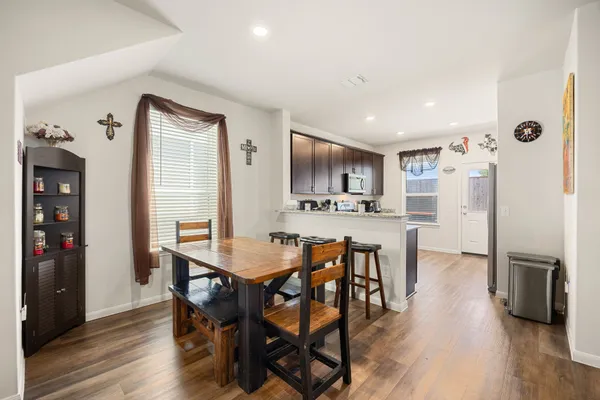 a view of a dining room with furniture and wooden floor