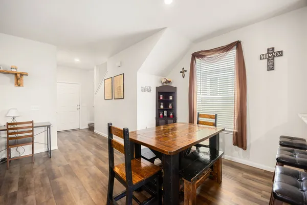 a view of a dining room with furniture and wooden floor