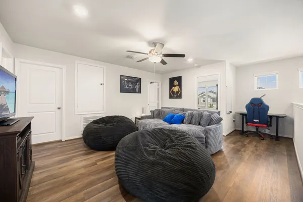 a spacious bedroom with a bed and wooden floor