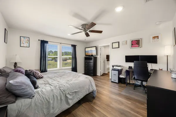 a bedroom with a bed and a desk