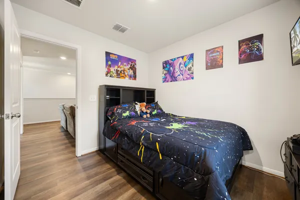 a bedroom with two beds and a desk
