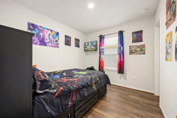 a bedroom with a bed and a bookshelf