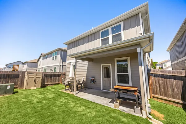 a view of a house with backyard porch and sitting area