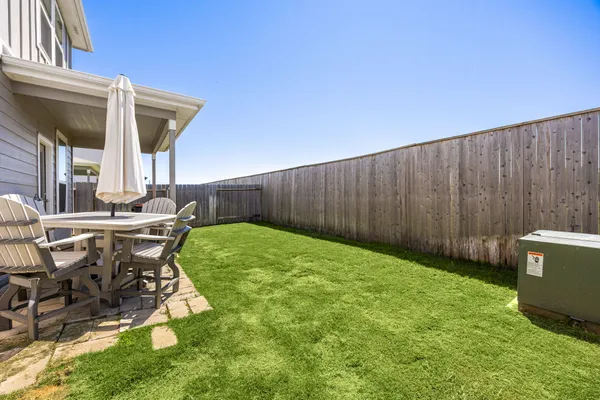 a view of backyard with outdoor seating