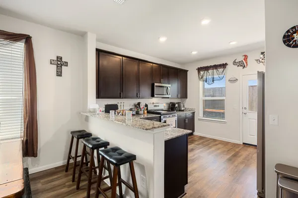 a kitchen with refrigerator and cabinets